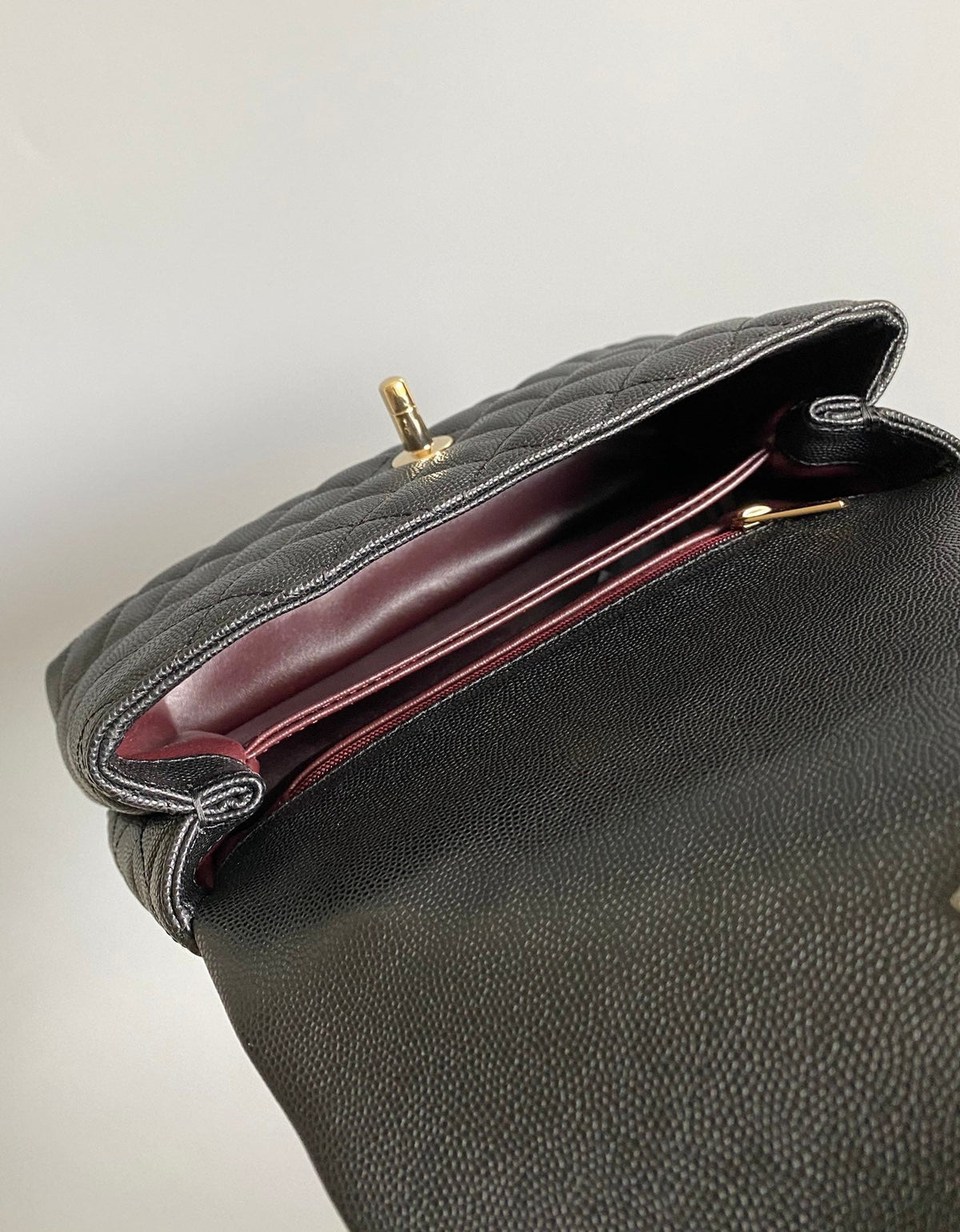 coco handle flap bag 23cm black quilted caviar with dark red top handle